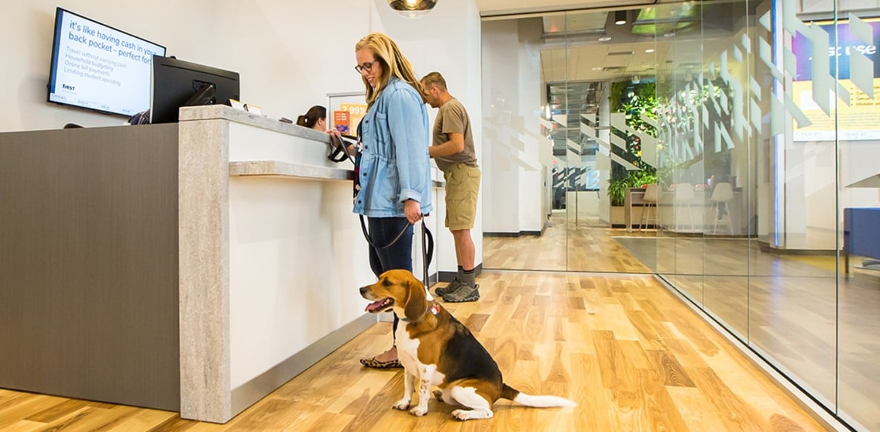 First Financial Bank client with dog inside 4th & Vine banking center