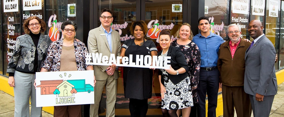 The #WeAreLHome Team in front of the building
