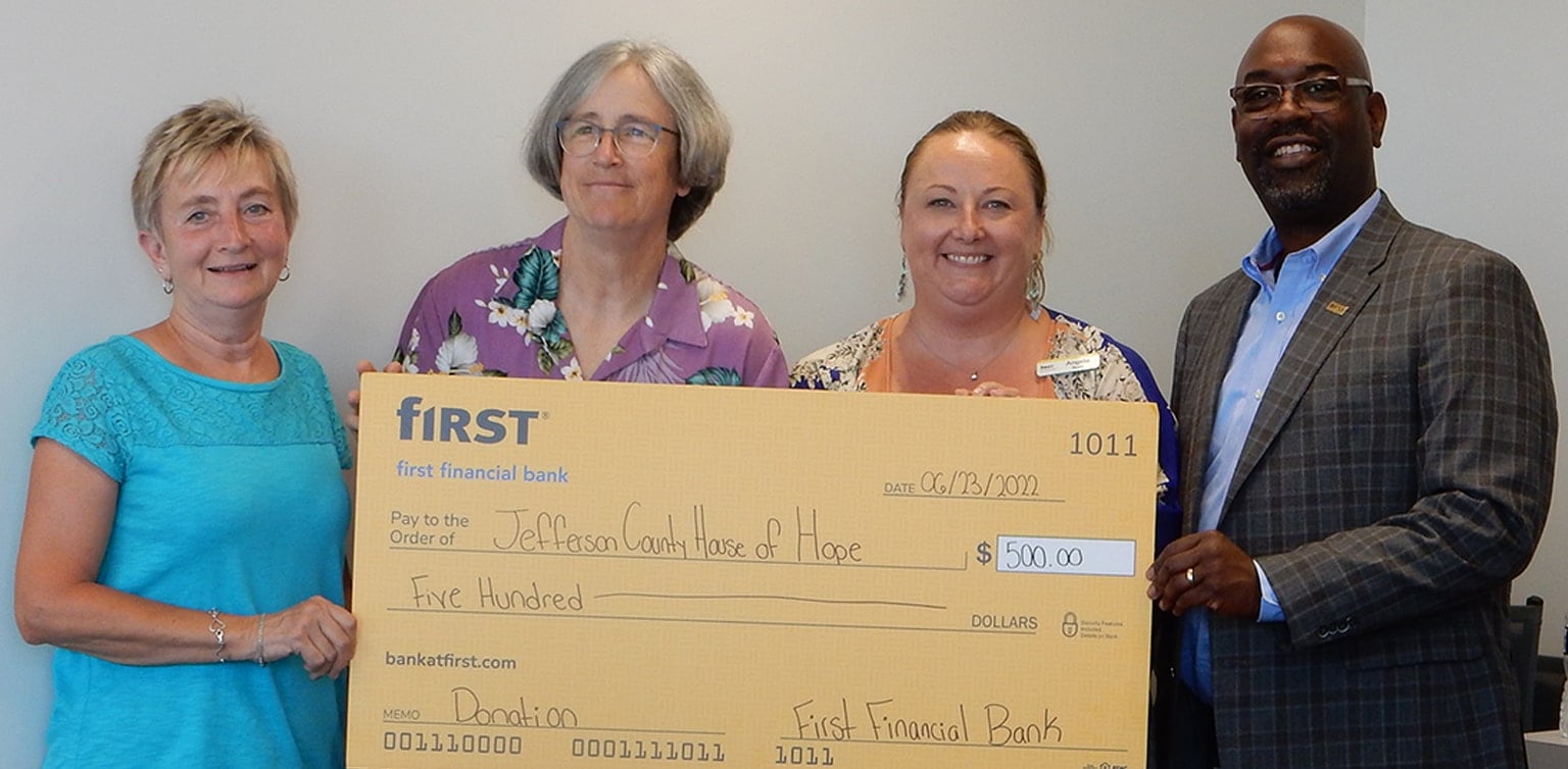 First Financial's Angela Byers and Roddell McCullough present a donation check to Jefferson County House of Hope