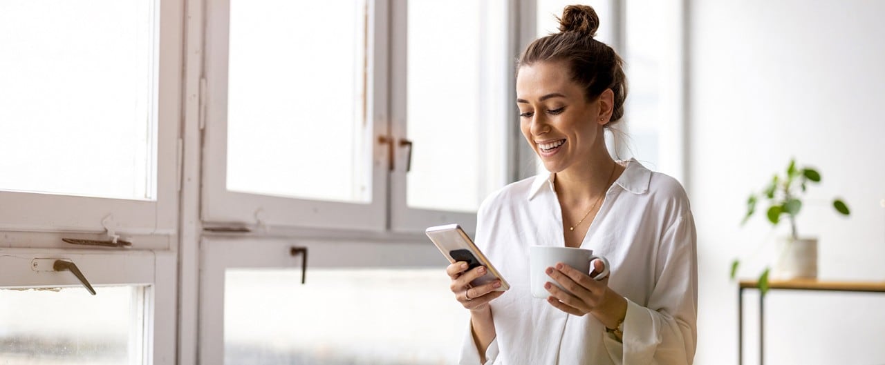 Shot of a young businesswoman using smartphone in an office