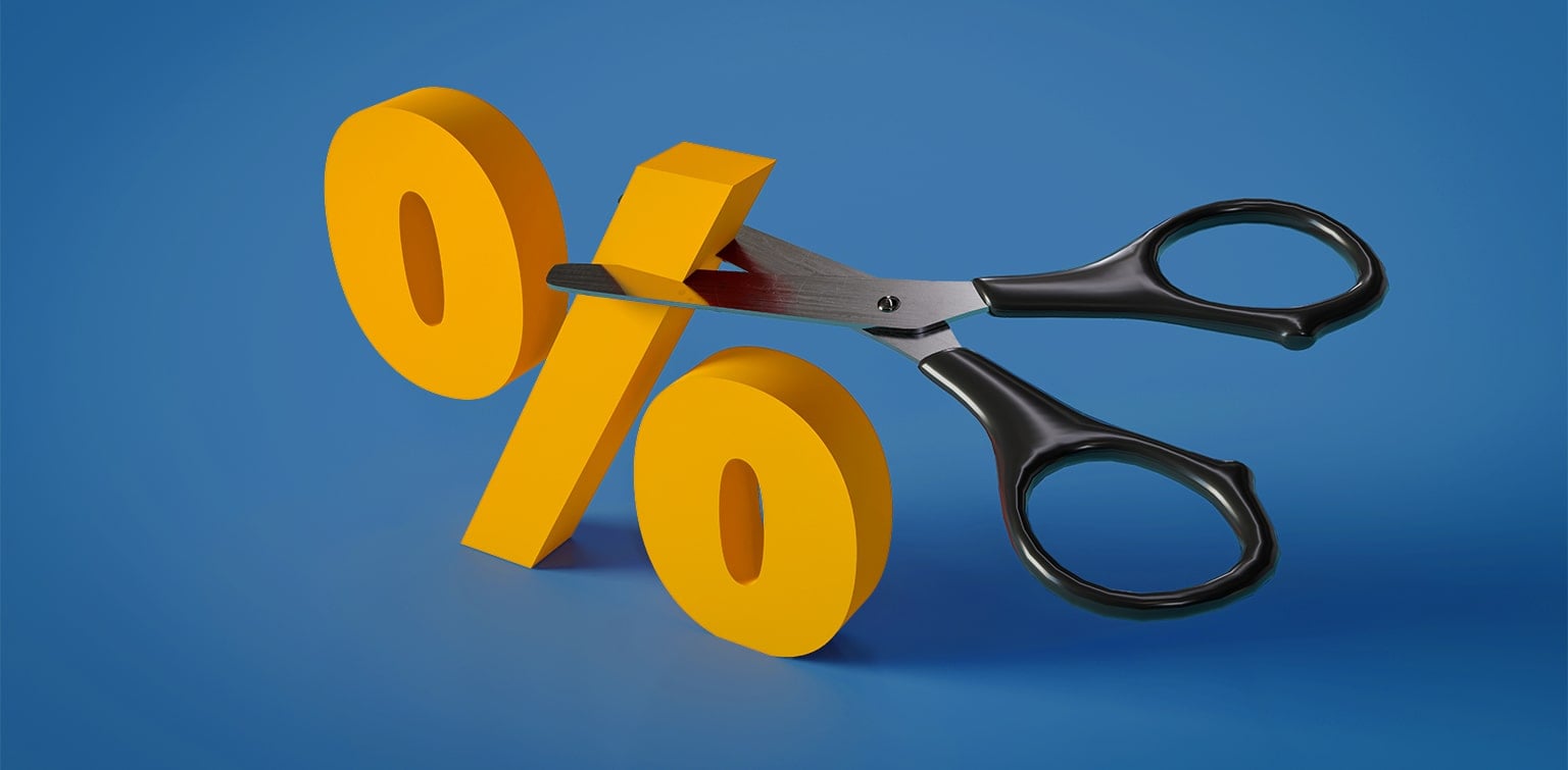 A pair of scissors cutting a yellow percentage sign