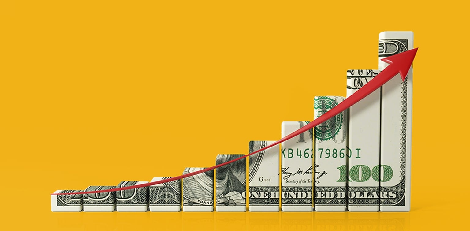 Bar graph made of $100 bill with red upward arrow illustrating growth