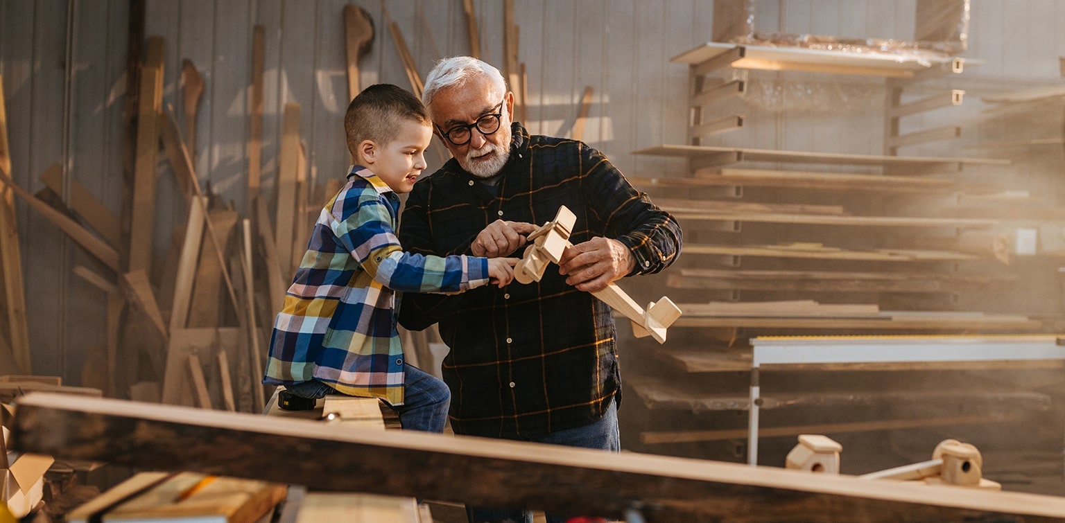 man with boy woodworking